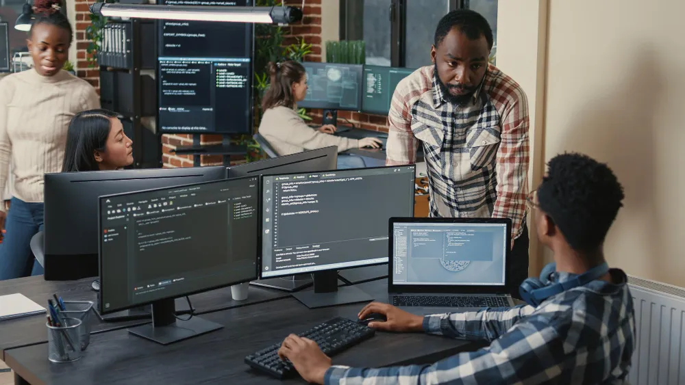 Hackathon participants coding together